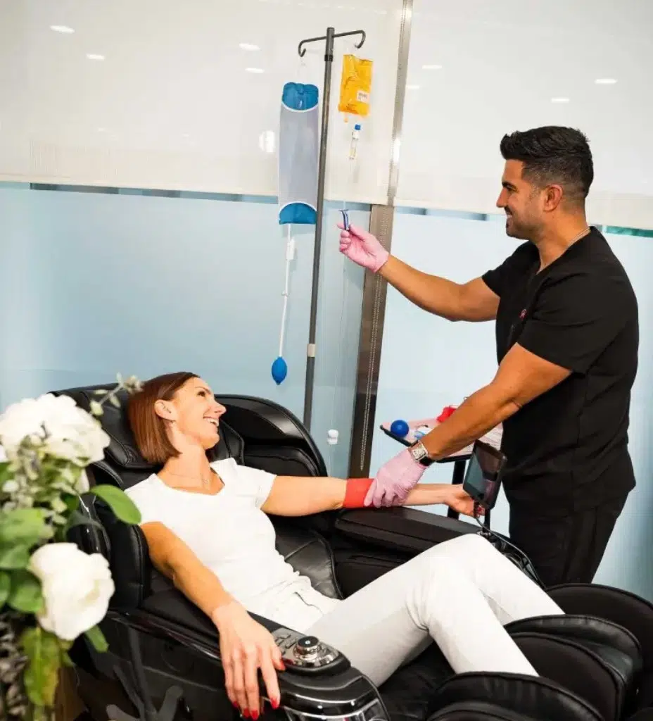 Casa Privee nutritional counselor with patient during vitamin IV therapy in Miami. IV therapy for energy, immunity, and anti-aging.